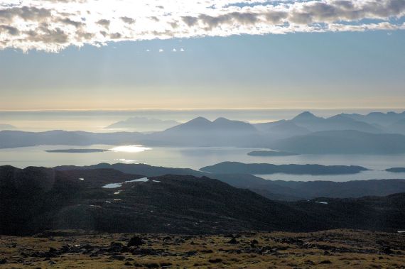 The car park at the top of the Bealach na Ba is 2,053 feet above sea level. From there can be seen dramatic views of Raasay and the Isle of Skye.
